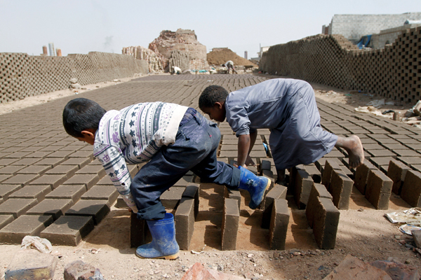 Boys arrange blocks at a brick factory on the outskirt of Sanaa, Yemen on May 28 (Reuters photo)